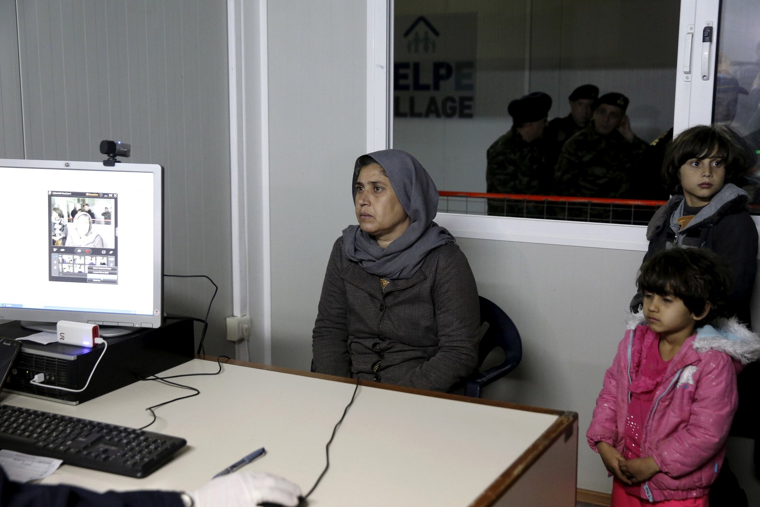 A Syrian refugee and her children are registered at the migrant registration centre on the Greek island of Chios, February 16, 2016. REUTERS/Alkis Konstantinidis/File Photo