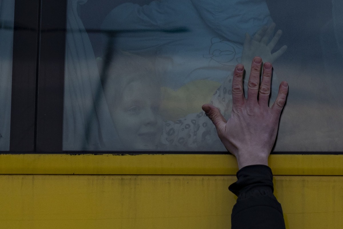 LVIV, UKRAINE - MARCH 03: A father says goodbye to his family as they leave for Poland on a bus on March 03, 2022 in Lviv, Ukraine. More than a million people have fled Ukraine following Russia's ...