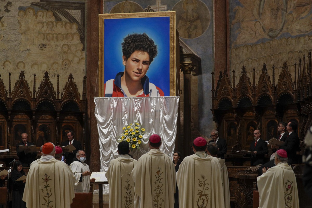 FILE - An image of 15-year-old Carlo Acutis, an Italian boy who died in 2006 of leukemia, is unveiled during his beatification ceremony celebrated by Cardinal Agostino Vallini in the St. Francis Basil ...