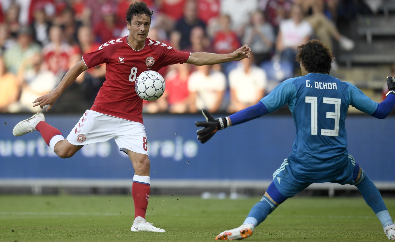 Denmark&#039;s Thomas Delaney take a shot at goal, as Mexico&#039;s goalkeeper Guillermo Ochoa defends, during the friendly soccer match between Denmark and Mexico at Brondby Stadium, in Brondby, Denm ...