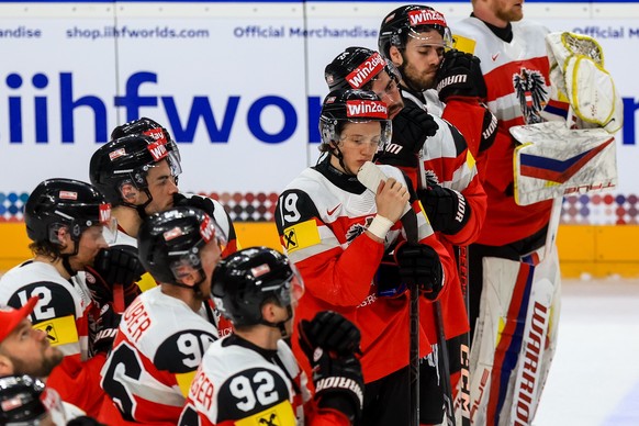 epa11357938 Vinzenz Rohrer (4-R) with his teammates are seen dejected after loosing the preliminary round group A match between Austria and Great Britain at the IIHF Ice Hockey World Championship 2024 ...