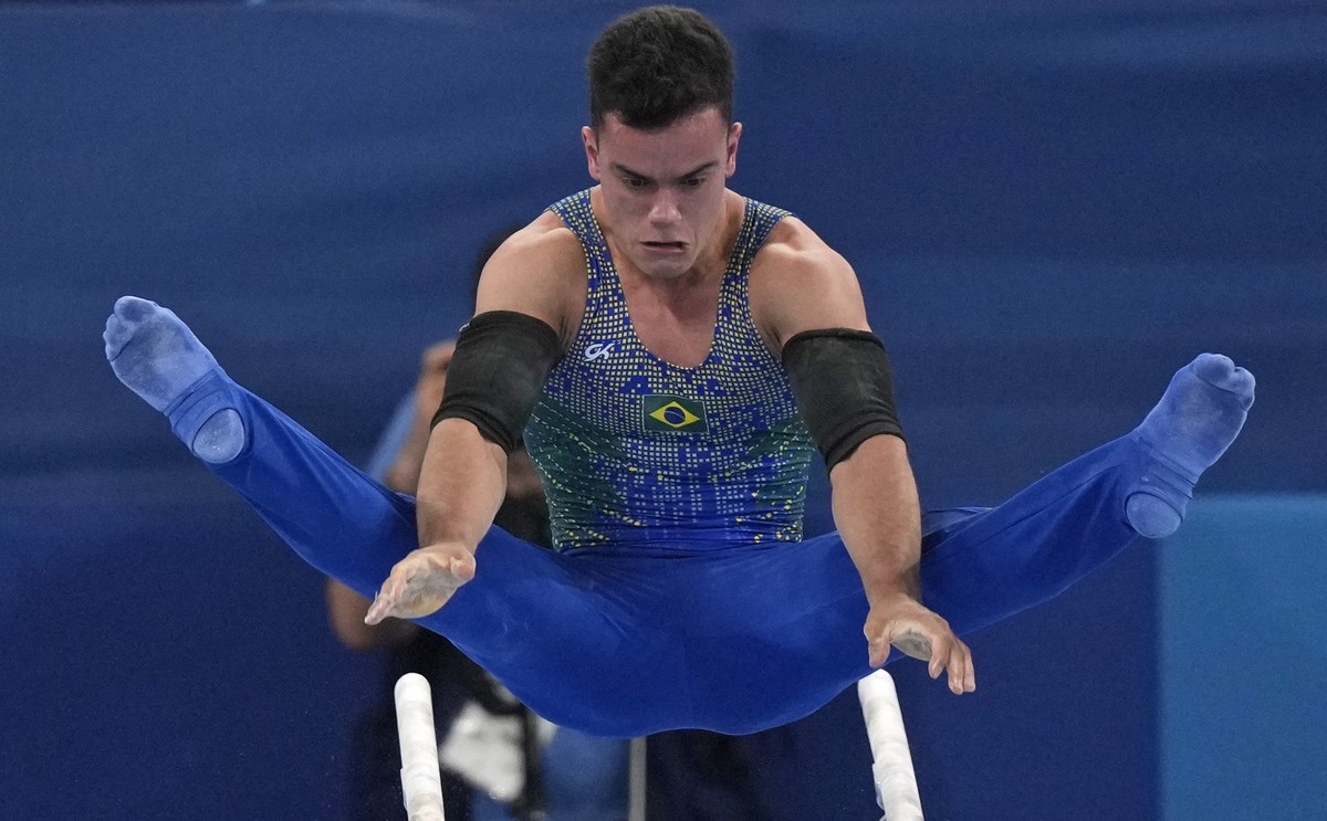 Caio Souza, of Brazil, performs on the parallel bars during the artistic gymnastic men's all-around final at the 2020 Summer Olympics, Wednesday, July 28, 2021, in Tokyo. (AP Photo/Gregory Bull)