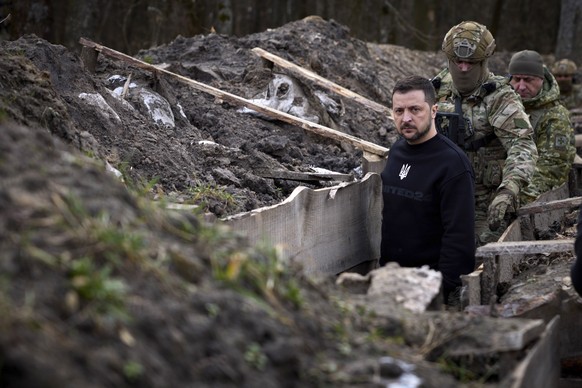 epa10547200 A handout photo made available by the Ukrainian Presidential Press Service shows Ukrainian President Volodymyr Zelensky walking through a trench at an undisclosed position of Ukrainian fro ...
