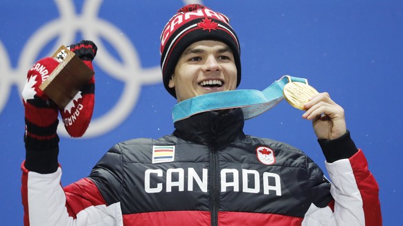 epa06521361 Gold medal winner Mikael Kingsbury of Canada during the medal ceremony for the men&#039;s Freestyle Moguls event during the PyeongChang 2018 Olympic Games, South Korea, 13 February 2018. E ...