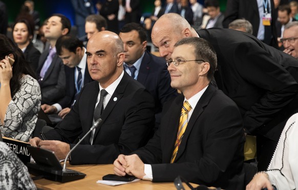 Swiss Federal President Alain Berset, Ambassador Juerg Burri, and Ambassador Franz Perrez, from left, discuss during the COP24 United Nations Climate Change Conference in Katowice, Poland, Monday, Dec ...