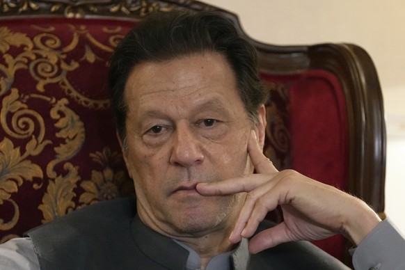 Pakistan&#039;s former prime minister Imran Khan listens to a member of media during talk with reporters regarding the current political situation and the ongoing cases against him at his residence, i ...