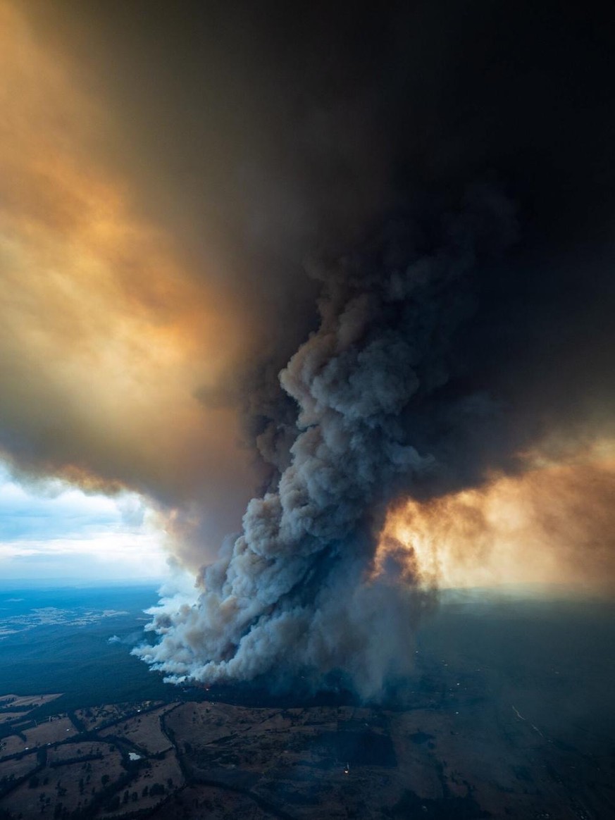 epa08098493 A handout photo made available by the Department of Environment, Land, Water & Planning of Gippsland region in Australia on 02 January 2020, showing smoke billowing from a fire burning ...