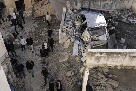 Palestinians look at the aftermath of an Israeli military raid on Jenin refugee camp in the West Bank on Wednesday, Nov. 29, 2023. (AP Photo/Majdi Mohammed)