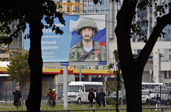 epa10147309 A billboard depicting a soldier with the slogan 'Glory to the Heroes of Russia' stands in St. Petersburg, Russia, 30 August 2022. On 25 August the Russian president signed a decree on incr ...