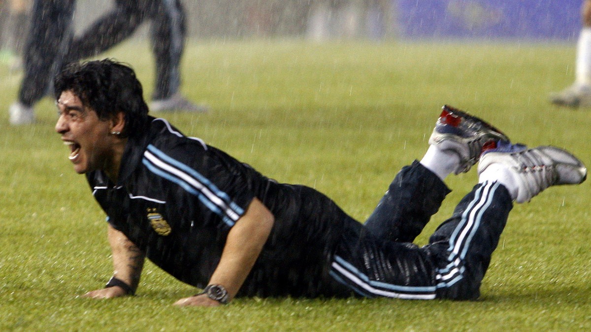 Under pouring rain, Argentina's coach Diego Maradona celebrates at the end of a 2010 World Cup qualifying soccer match against Peru in Buenos Aires, Saturday, Oct. 10, 2009. Argentina won 2-1. (A ...