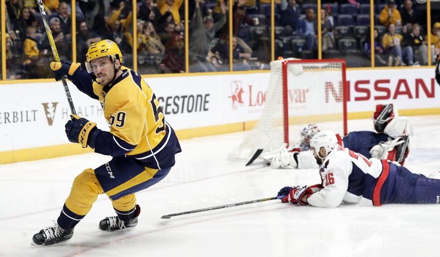 Nashville Predators defenseman Roman Josi (59), of Switzerland, celebrates after scoring a goal against Washington Capitals goalie Philipp Grubauer, upper right, of Germany, and left wing Daniel Winni ...