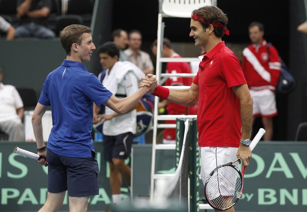 Swiss Davis Cup tennis player Roger Federer, right, shakes hands with Simon Ammann, Swiss ski jumping Olympic Champion, after a short training session in the Postfinance Arena in Bern, Switzerland, Th ...
