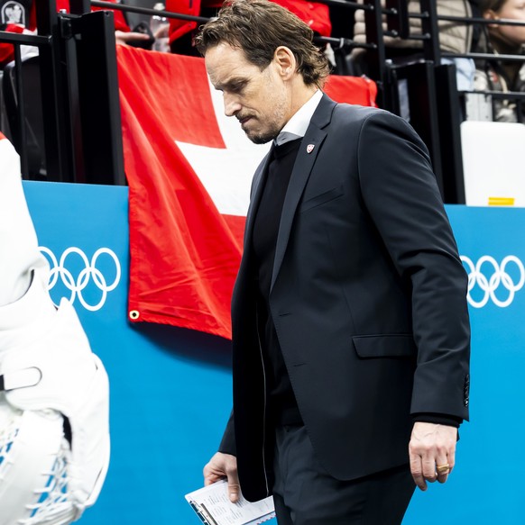 Patrick Fischer, head coach of Switzerland national ice hockey team, looks disappointed as they leave his bench after the second period, during the men's group A preliminary round game between Ca ...