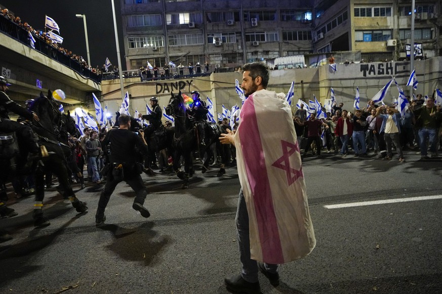 Israeli policemen on horseback disperse protesters blocking a highway during a protest against Prime Minister Benjamin Netanyahu's government plans to overthrow the judicial system in…