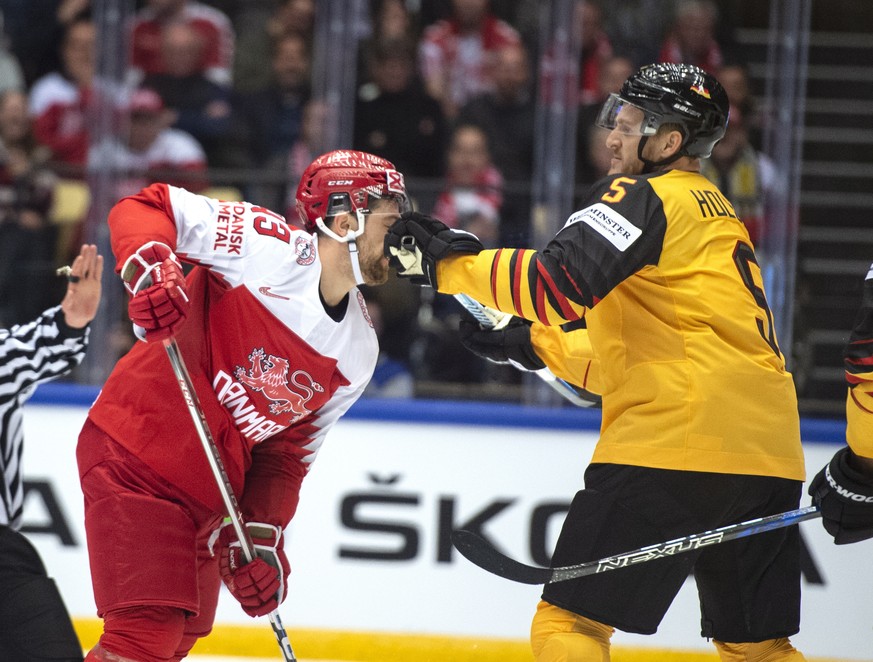 epa06711551 Nichlas Hardt (L) of Denmark receives a blow from Korbinian Holzer (R) of Germany during the IIHF World Championship Group B match between Germany and Denmark in Jyske Bank Boxen in Hernin ...