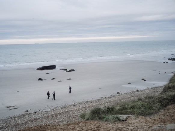 French police officers patrol on the beach in the searcher migrants in Wimereux, northern France, Wednesday, Nov.17, 2021. Several migrants died and others were injured Wednesday Nov.24, 2021 when the ...