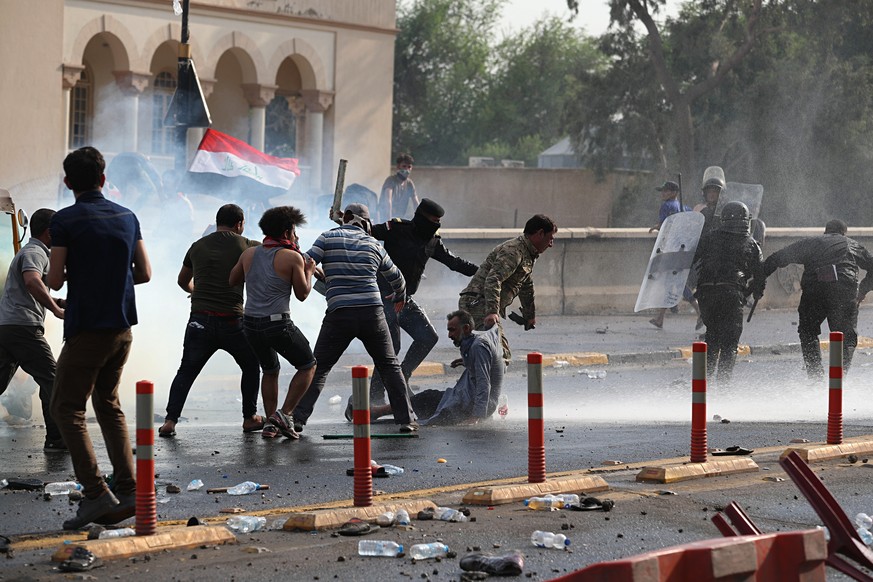 Iraq security forces arrest a protester during a protest in Tahrir Square, in central Baghdad, Iraq, Tuesday, Oct. 1, 2019. Iraqi security forces fired tear gas on hundreds of protesters in the Iraqi  ...