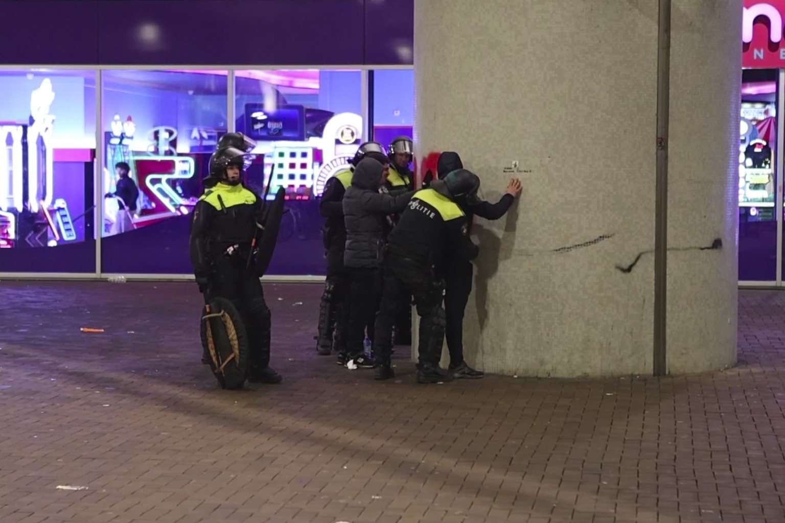 In this image taken from video, police frisk pro-Palestinian supporters near the Ajax stadium in Amsterdam, the Netherlands, Thursday, Nov. 7, 2024. (AP Photo InterVision)