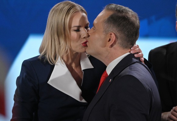epa12149906 Polish presidential candidate Karol Nawrocki (2R) with his wife Marta (2L), daughter Kasia (L) and son Antoni (R) during the presidential election night in Warsaw, Poland, 01 June 2025. Ac ...