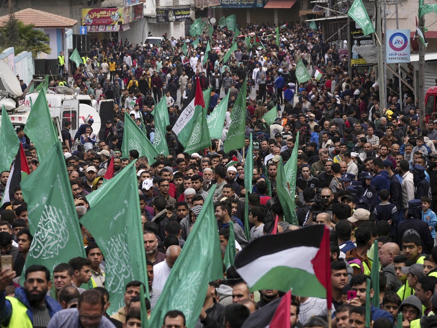 Hamas supporters wave green Islamic flags during a rally in solidarity with Palestinian residents of the West Bank and Jerusalem, at the main road of Jebaliya refugee camp, northern Gaza Strip, Friday ...