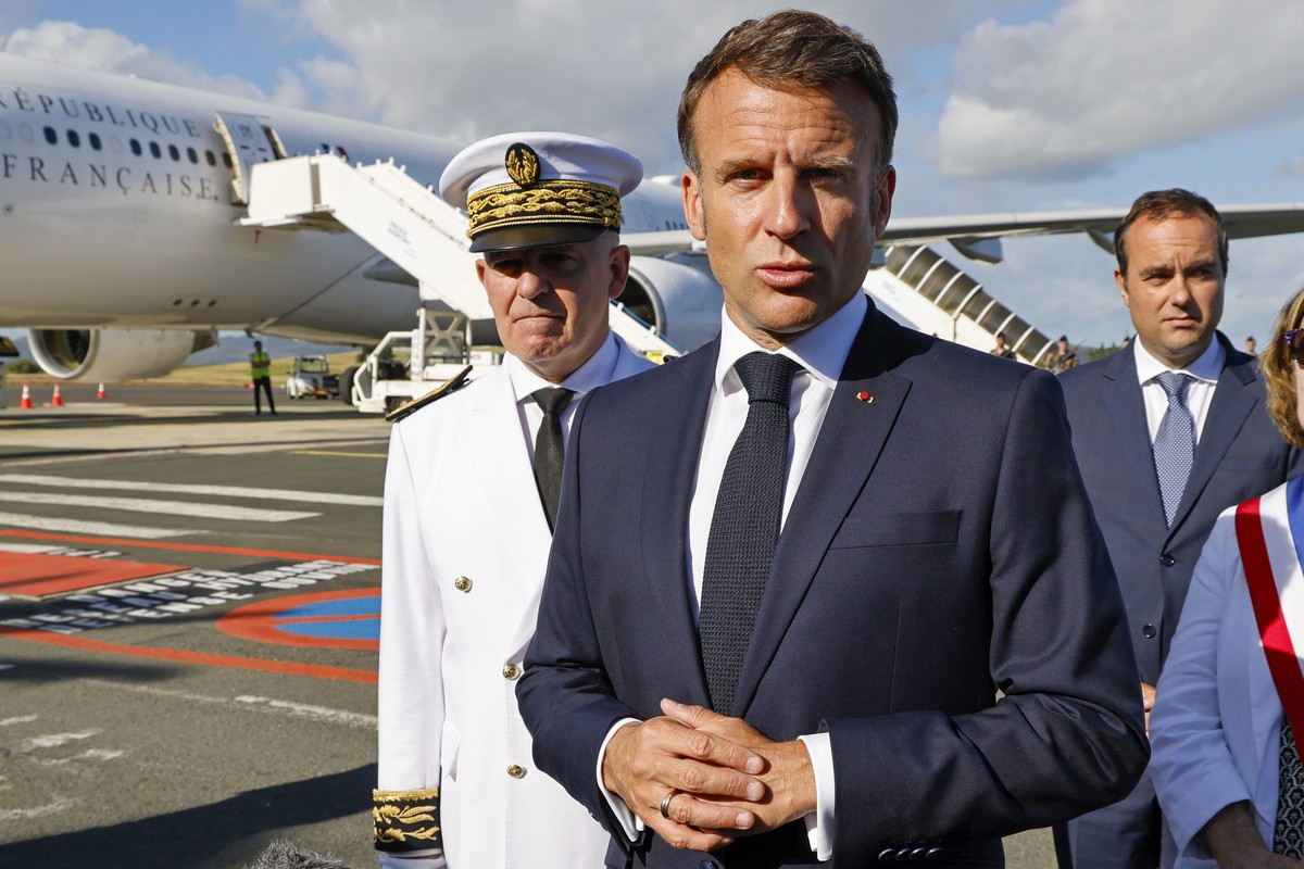 French President Emmanuel Macron speaks with the press upon arrival at Noumea