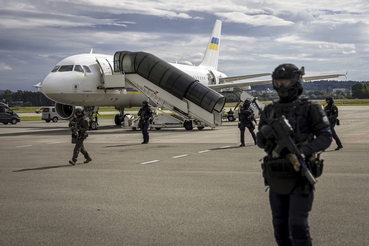 Security forces secure the area during the arrival of Ukrainian President Volodymyr Zelenskyy, at Zurich airport in Zurich Kloten, Switzerland on Friday June 14, 2024. Zelenskyy will attend the Summit ...