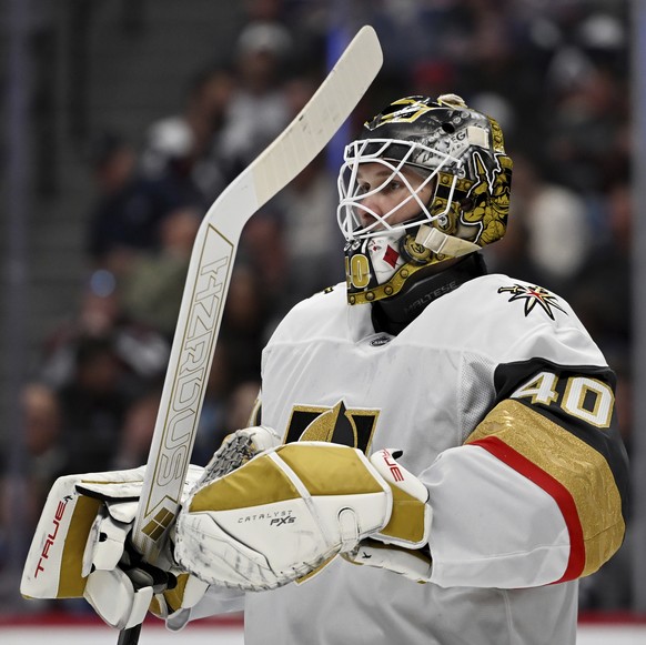 Vegas Golden Knights goaltender Akira Schmid (40) looks on during a pause in play in the first period of an NHL hockey game against the Colorado Avalanche Tuesday, April 8, 2025, in Denver. (AP Photo/ ...