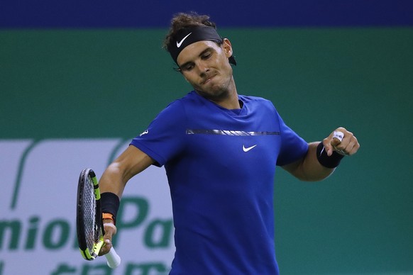 Rafael Nadal of Spain reacts after broke a serve by Marin Cilic of Croatia during their men&#039;s singles semifinals match in the Shanghai Masters tennis tournament at Qizhong Forest Sports City Tenn ...