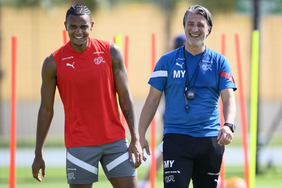 epa10312489 Switzerland&#039;s head coach Murat Yakin (R) and Manuel Akanji (L) attend their team&#039;s training session in preparation for the FIFA World Cup 2022 at the University of Doha for Scien ...