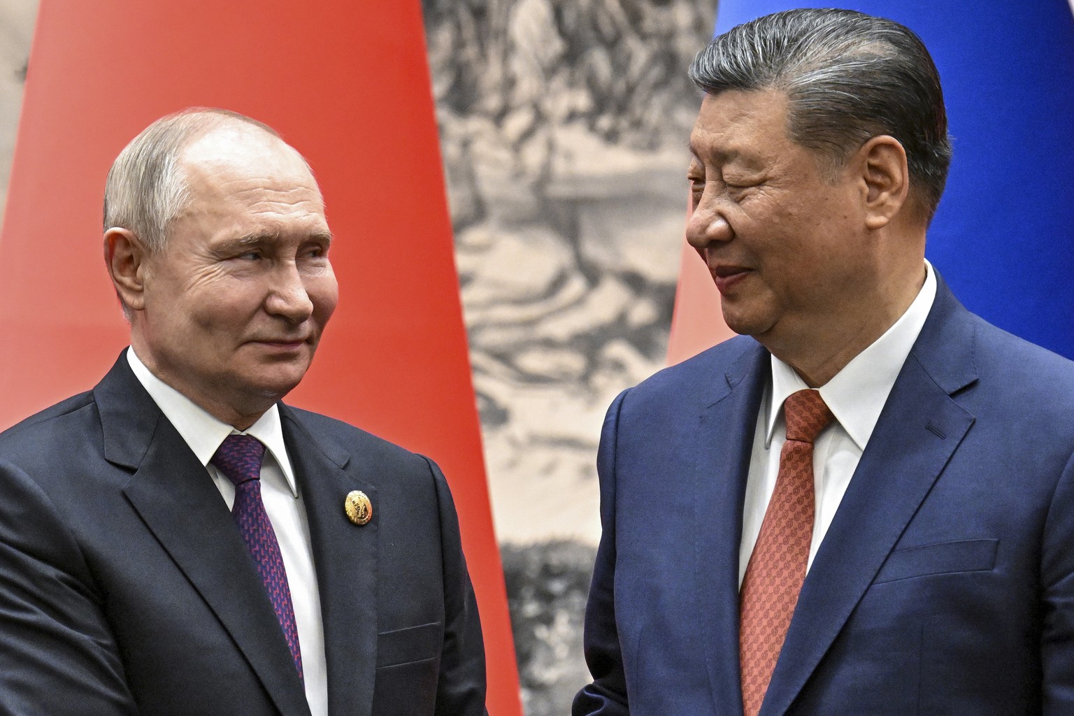 Chinese President Xi Jinping, right, and Russian President Vladimir Putin shake hands prior to their talks in Beijing, China, on Thursday, May 16, 2024. (Sergei Bobylev, Sputnik, Kremlin Pool Photo vi ...
