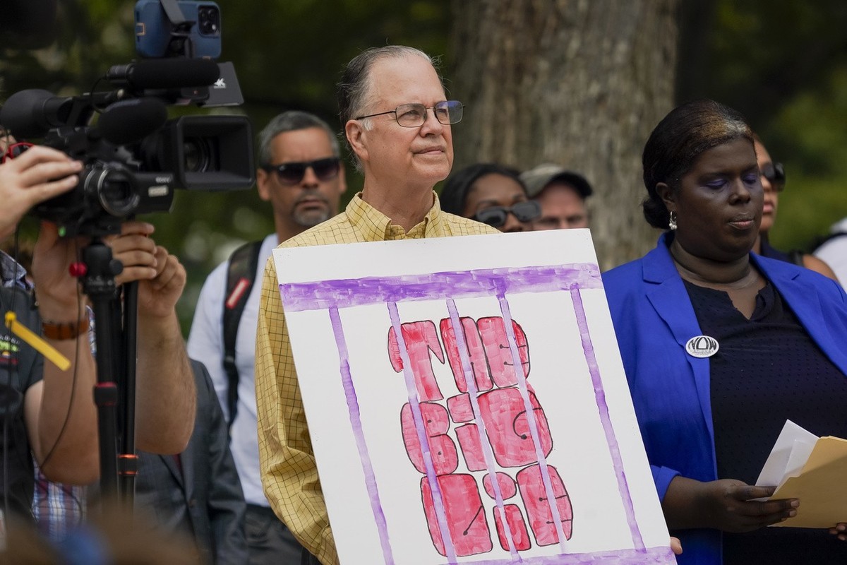 A protestor holds a sign that says "The Big Lie" as activists gather near the U.S. Capitol, Thursday, Aug. 3, 2023, in Washington. Former President Donald Trump is due in federal court Thurs ...