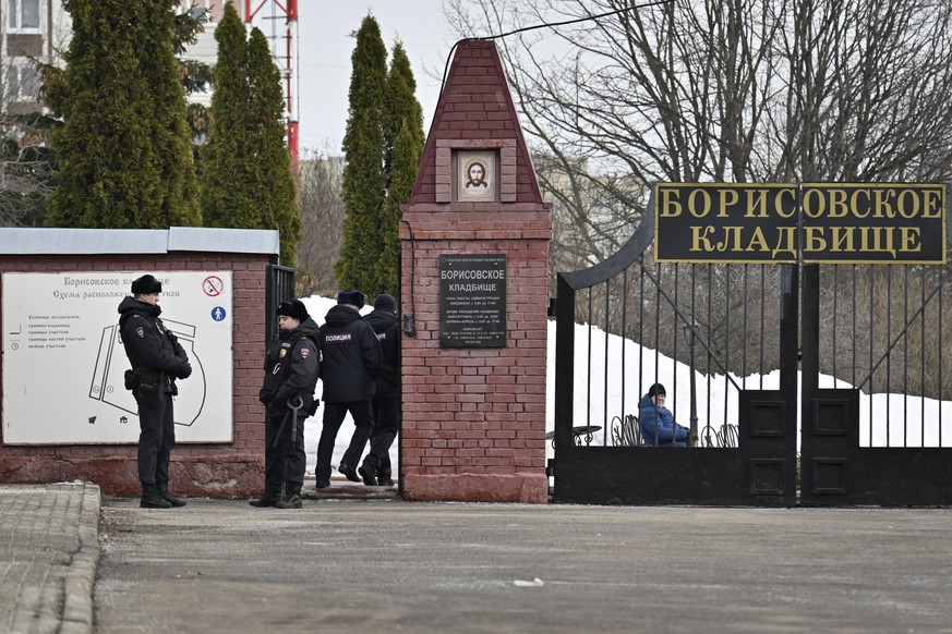 Police officers stand guard at the Borisovskoye cemetery where the funeral of Russian opposition leader Alexei Navalny will take place on Friday, March 1, 2024 in Moscow, Russia, Thursday, February 29, 2024…