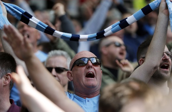 Manchester City fans cheer on the stands before the start of the English Premier League soccer match between Brighton and Manchester City at the AMEX Stadium in Brighton, England, Sunday, May 12, 2019 ...