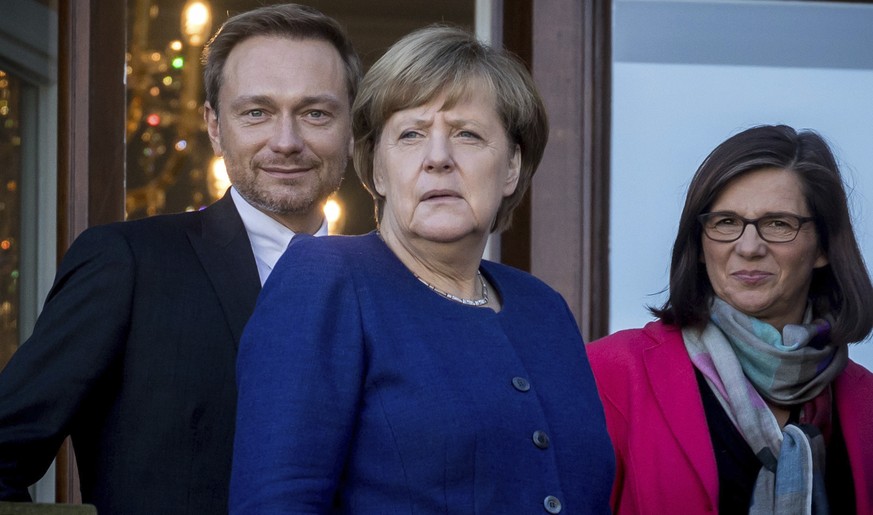 Chancellor Angela Merkel, center, Free Demoratic Party chairman Christian Lindner, left, and Katrin Goering-Eckardt, group chairwoman of the Greens in the parliament stand on the balcony of the German ...