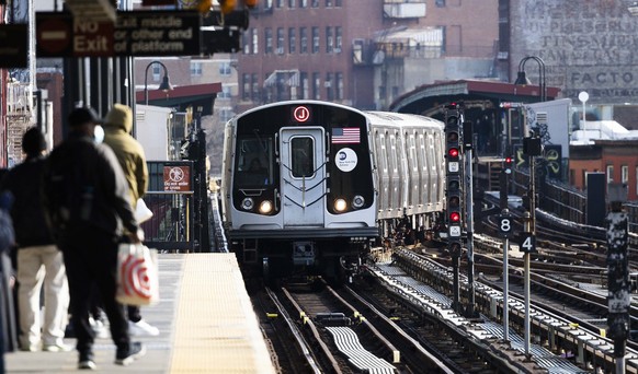 epa08869065 People wait for an arriving train in Brooklyn, New York, USA, 07 December 2020. The Metropolitian Transportation Authority, the agency that operates public transportation in New York, is e ...