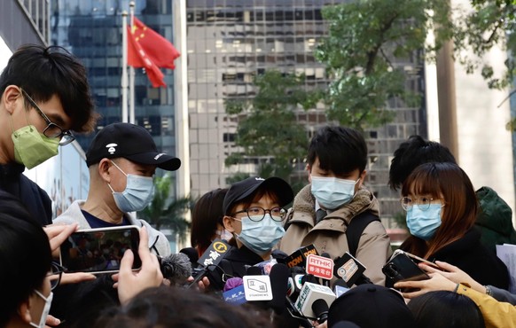 December 21, 2020, Hong Kong, CHINA: Families of 12 Hong Kong Fugitives, wife of detainee Wong Wai-yin centre and father of detainee Li Tsz-yin left with cap receiving interviews outside Immigration D ...