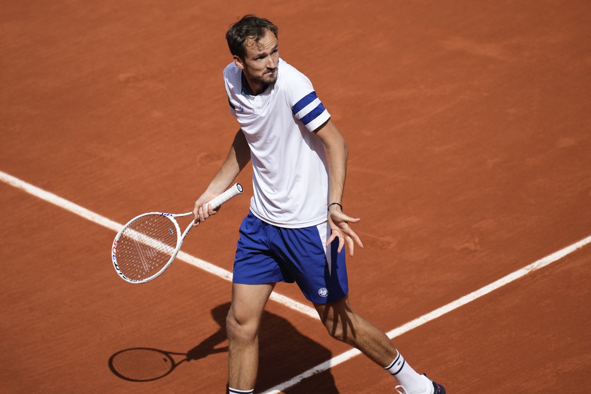 Russia's Daniil Medvedev gestures after missing a shot against Australia's Alex De Minaur during their fourth round match of the French Open tennis tournament at the Roland Garros stadium in ...