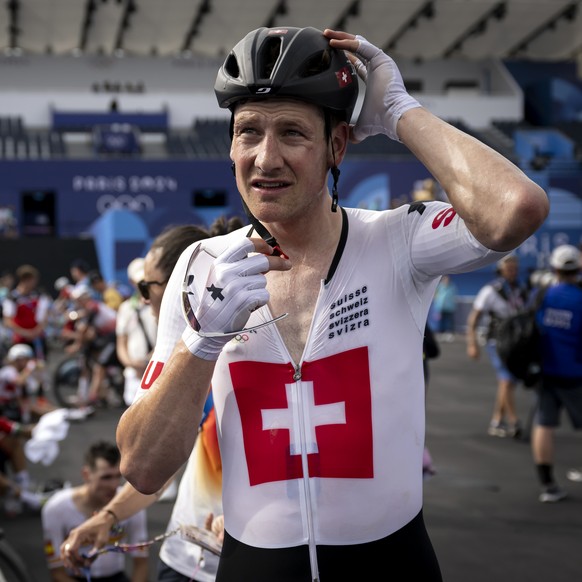 Stefan Kueng of Switzerland, looks disappointed after crossing the finish line, during the men&#039;s cycling road race at the 2024 Paris Summer Olympics in Paris, France, Saturday, August 3, 2024. (K ...