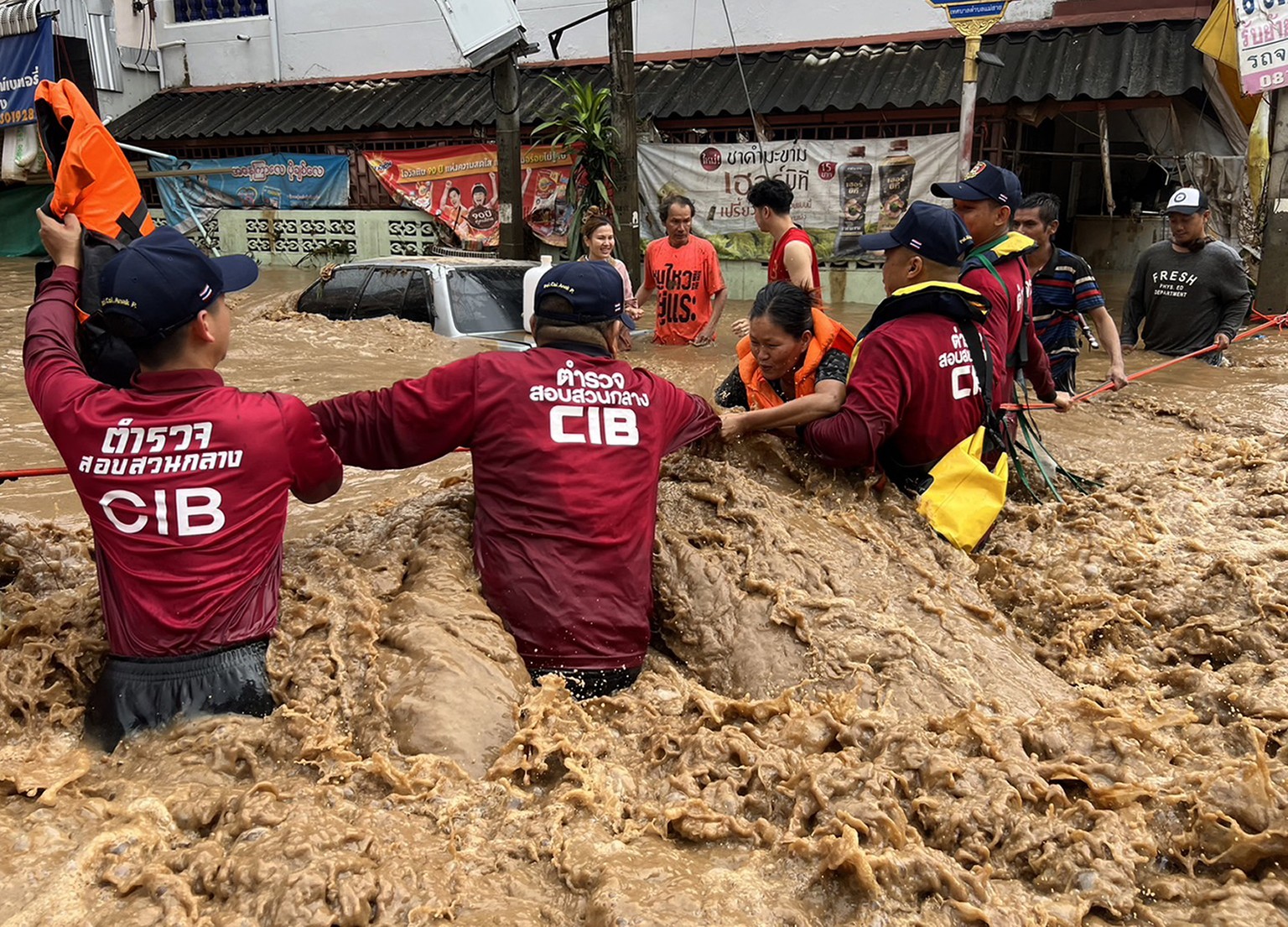 epaselect epa11599562 A handout photo made available by Central Investigation Bureau (CIB) shows CIB personnel helping flood victims during flooding due to heavy rain in urban areas of Chiang Rai Prov ...