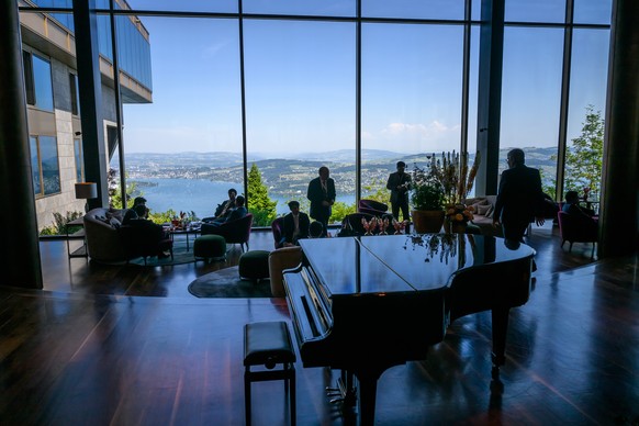 Delegates are seen in silhouette in the lobby of the Burgenstock luxury hotel complex overlooking Lake Lucerne, Switzerland, on June 21, 2026, ahead of high-level talks aimed at advancing a deal to en ...