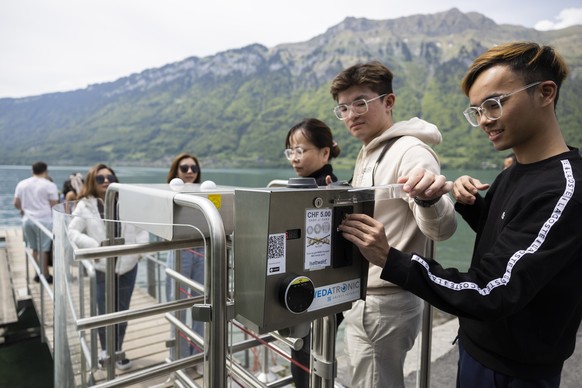 Korean visitors pay 5 Swiss Francs to get on the pier in Iseltwald, Switzerland, Sunday, May 21, 2023. Lots of Asian TV fans and tourists visit the place because the romantic Korean Netflix drama &#03 ...