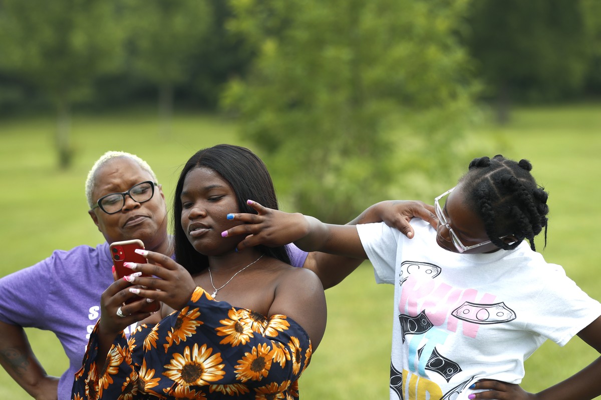 Zakia Buchanan, center, shows TikTok videos to her mom, Delicia Harris, left, as her youngest sister Antoinette Harris, touches her face Thursday, July 22, 2021 at Rock Cut State Park in Loves Park, I ...