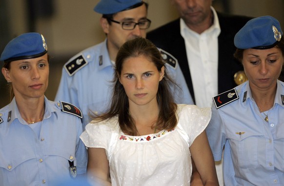 FILE - In this Tuesday Sept. 16, 2008 file photo, American murder suspect Amanda Knox, center, is escorted by Italian penitentiary police officers from Perugia&#039;s court after a hearing, central It ...