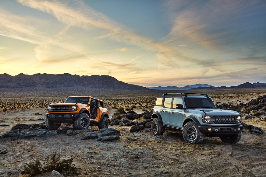 Pre-production versions of the 2021 Bronco, shown here, include Bronco two-door in Cyber Orange Metallic Tri-Coat and Bronco four-door in Cactus Gray. 2021 Ford Bronco 4x4 offroader auto retro design  ...