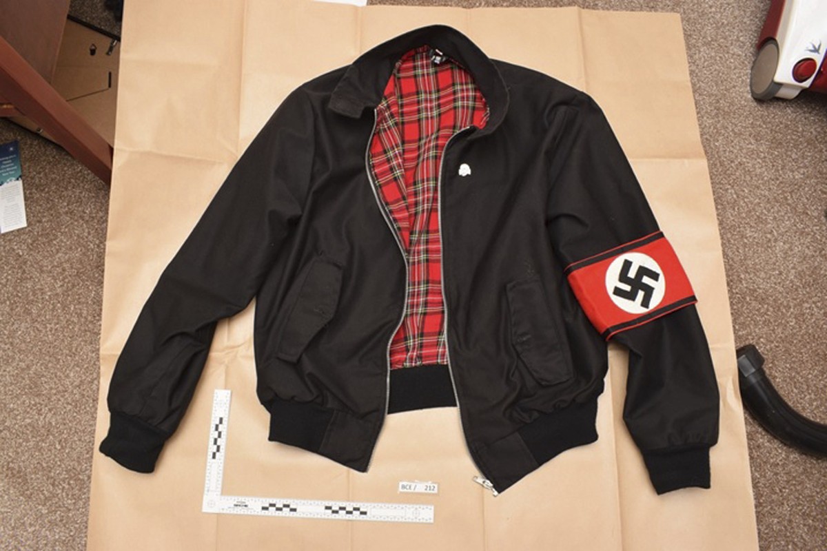In this undated photo issued Monday Nov. 12, 2018, by Britain's West Midlands Police, showing a jacket bearing a Swastika armband found during police searches of Adam Thomas and Claudia Patatas&# ...