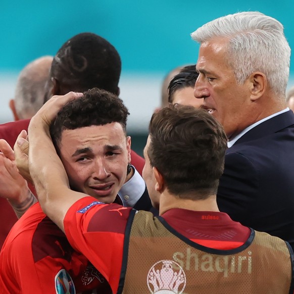 epa09318798 Swiss headcoach Vladimmir Petkovic (R) comforts Ruben Vargas (L) after losing the UEFA EURO 2020 quarter final match between Switzerland and Spain in St.Petersburg, Russia, 02 July 2021. E ...