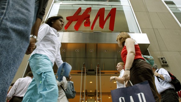 Pedestrians walk past the Fifth Avenue store owned by Stockholm-based fashion retailer Hennes and Mauritz (H and M) Wednesday, June 21, 2006, in New York. HandM posted a 12 percent increase in second- ...