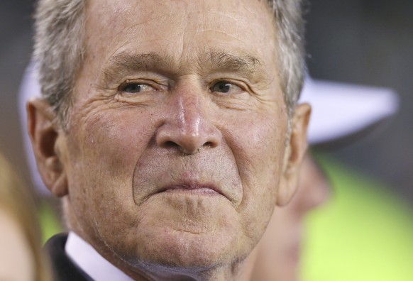 FILE - In this Nov. 11, 2018 file photo, President George W. Bush stands on the sidelines before an NFL game in Philadelphia. Bush is endorsing Republican Sen. Susan Collins in his first public endors ...