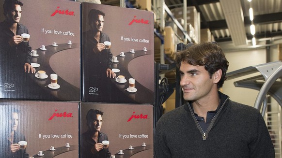 Roger Federer poses next to a fork truck in the warehouse of the headquarters of Jura coffee machines in Niederbuchsiten, on Saturday, October 20, 2012. (KEYSTONE/Georgios Kefalas)