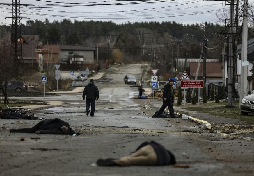 Bodies lie on a street in Bucha, northwest of Kyiv, as Ukraine says Russian forces are making a &quot;rapid retreat&quot; from northern areas around Kyiv and the city of Chernigiv, on April 2, 2022. T ...
